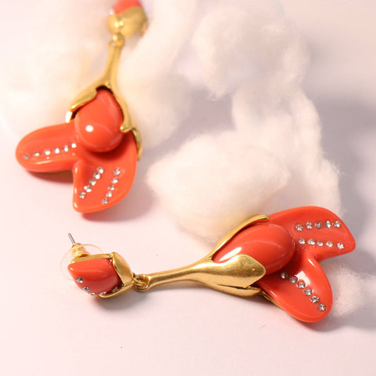 Coral flower resin drop earrings with gold-tone hooks and rhinestone speckling