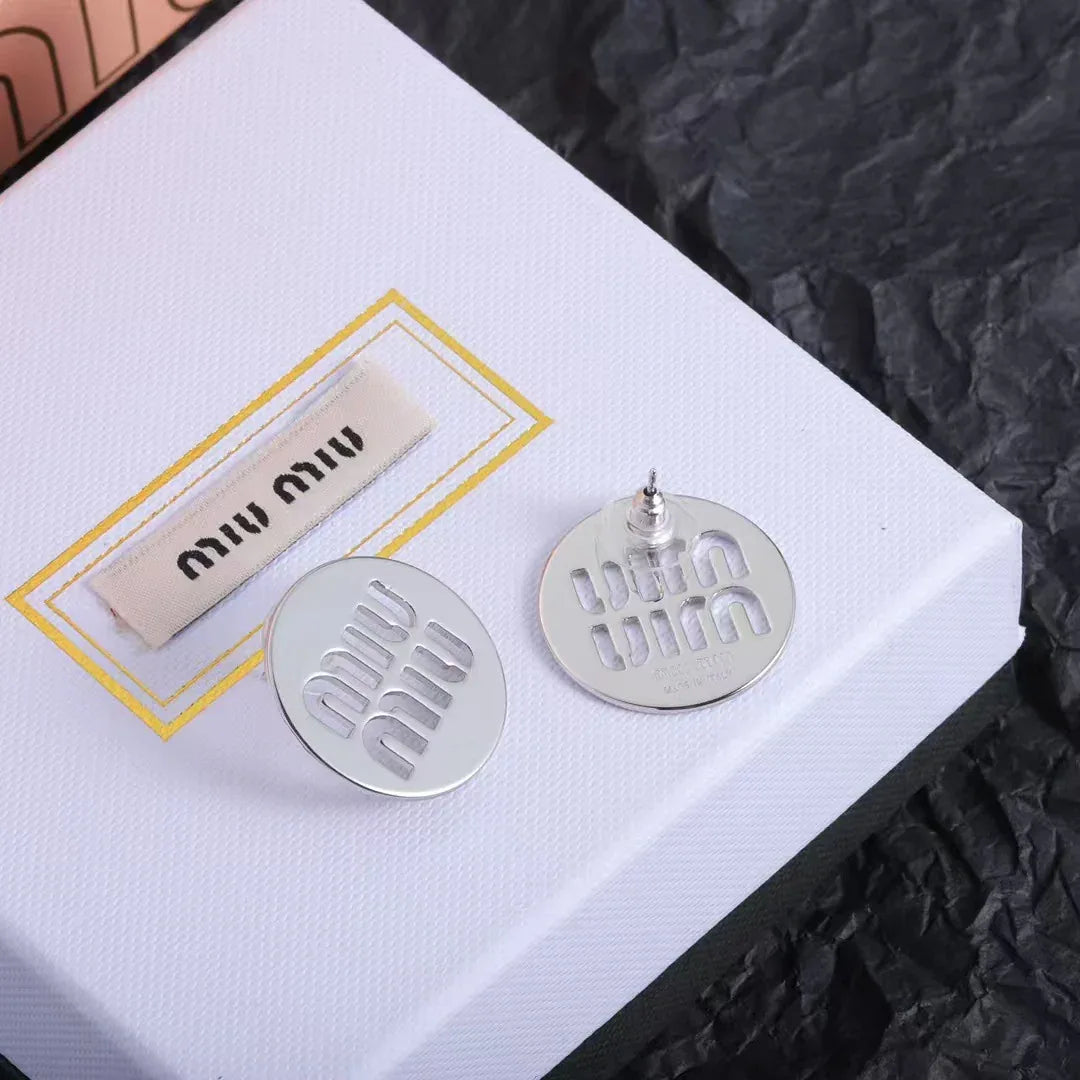 White gold tone round stud earrings with hollow Miu Miu logo detailing