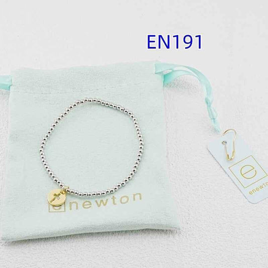 Enewton blessed bracelet with silver bead rope and gold disc charm, lying flat