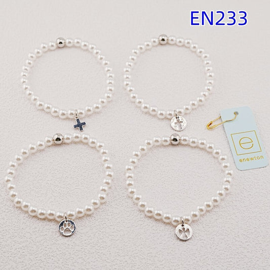 Set of four pearl strand bracelets with silver charms in paw, cross, and heart styles