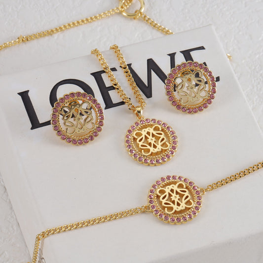 Gold necklace pendant with purple gem halo monogram and matching round stud earrings