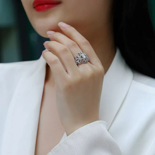 Moissanite wedding ring on hand with sparkling pavé design and silver setting