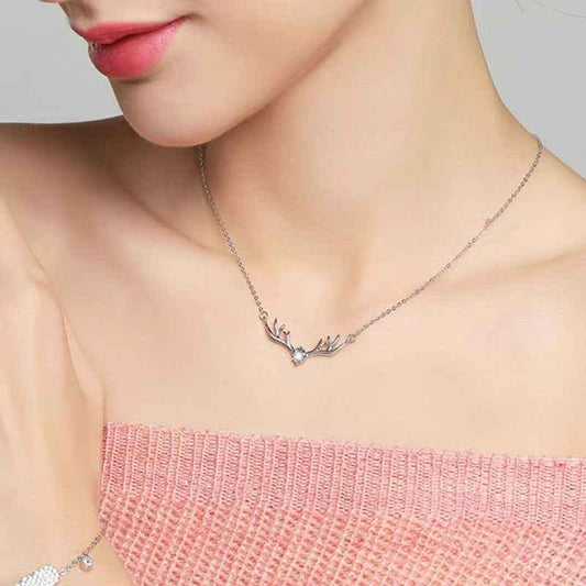 Reindeer antler necklace with blue gemstone center on a fine silver chain