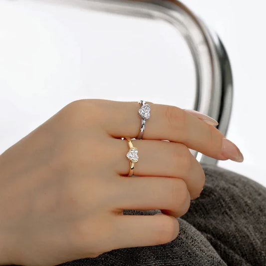 Gold-tone cz heart promise ring on finger, round center stone in heart-shaped setting