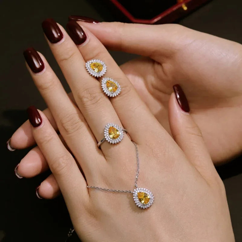 CZ jewelry set on hand: pear-cut yellow ring and matching pendant necklace