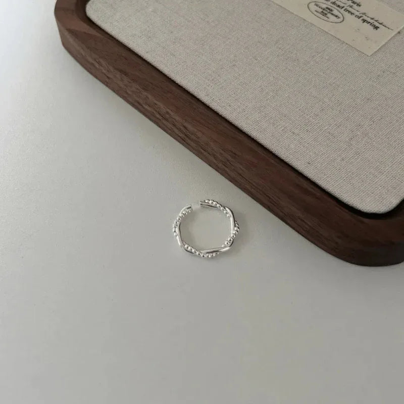 Sterling silver open geometric beaded ring, double-layer design on display