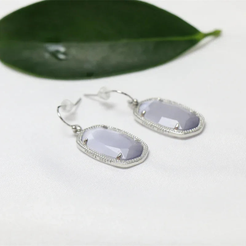 Silver-tone oval lavender stone drop dangle earrings with pavé edge and hook backs
