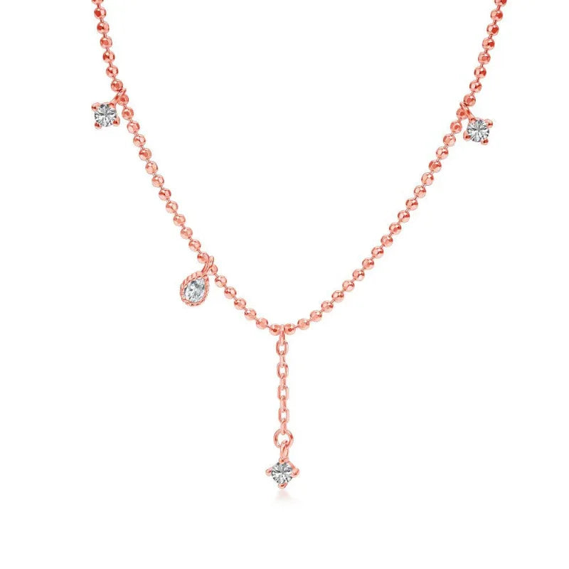 Infinity cubic zirconia necklace in rose gold tone with three dangling cubic zirconia stone charms