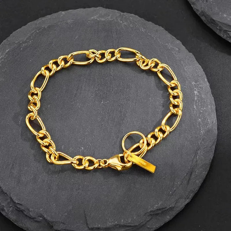 Gold chain bracelet with chunky oval links and small rectangular tag clasp