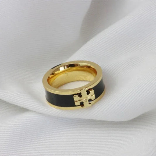 Gold-tone enamel ring with black enamel band and square logo detail
