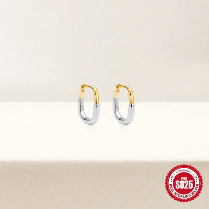 Pair of gold and white-gold U-shape hoop earrings, polished metal finish