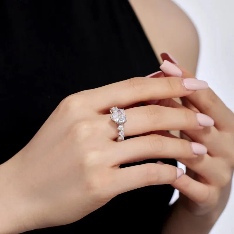 Silver heart-shaped eternity band with pink center heart CZ and clear stones on band
