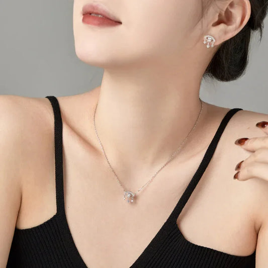 Silver-tone evil eye pendant necklace with round CZ centerpiece and subtle dangling drops