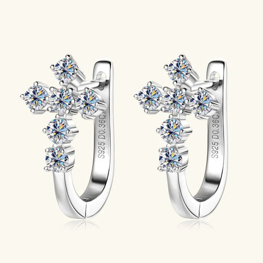Silver cross huggie earrings with round moissanite-style stones on a hoop setting