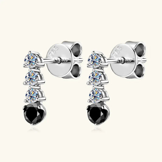Silver-tone drop earrings with three clear moissanite stones and a black onyx teardrop