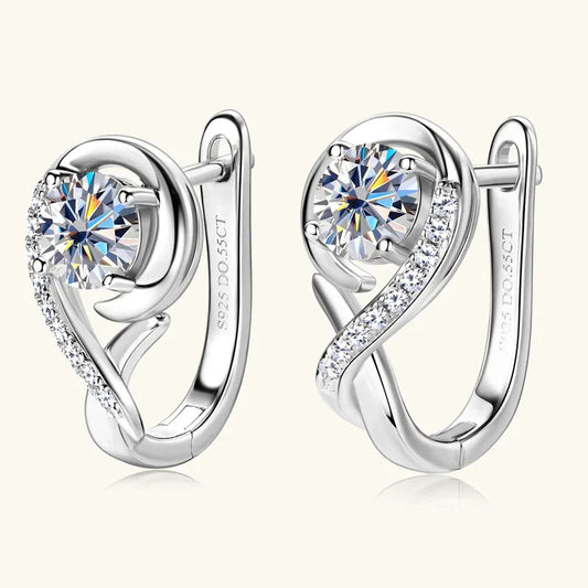Silver curved hoop earrings with round pavé moissanite centers and side sparkle stones