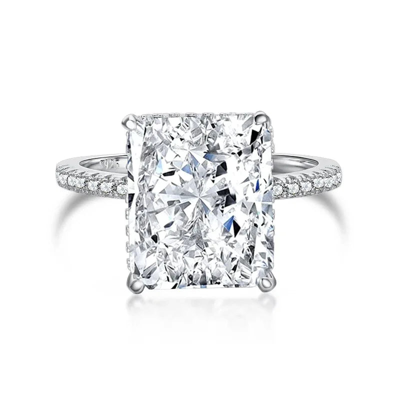 Silver-toned ring with large radiant-cut clear center stone and crystal pavé band