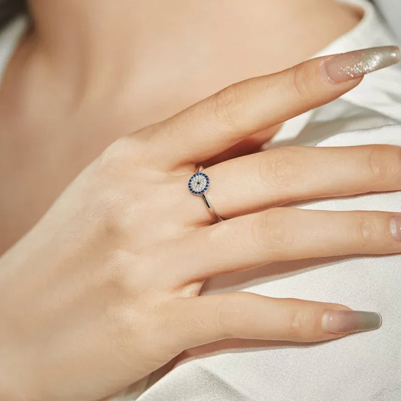 Sterling silver demon eye CZ ring, round blue halo with yellow center on finger