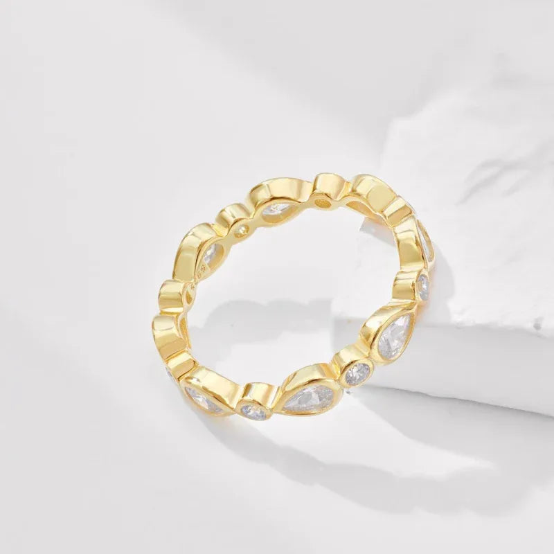Gold teardrop CZ eternity ring with faceted teardrop stones on the band