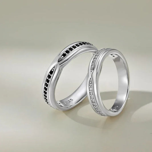 Silver couple eternity rings with black pavé center and small clear stones
