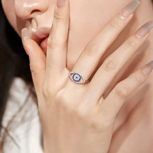 Sterling silver evil eye ring on hand with blue CZ oval centerpiece