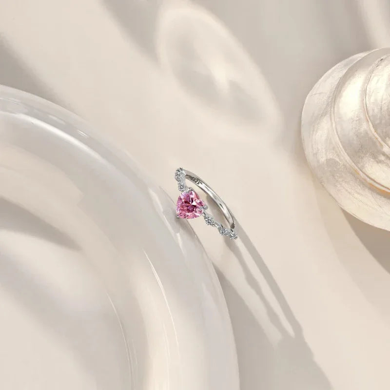Sterling silver heart CZ ring with raised pink heart center and pavé side sparkle stones