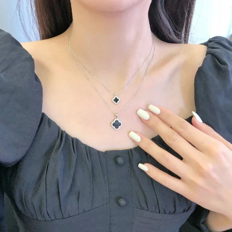 White gold four-leaf clover pendant necklace with blue and dark enamel, two clover charms