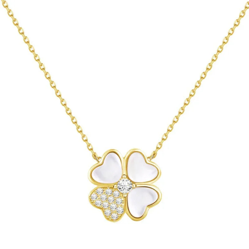 Gold-tone four-leaf clover pendant necklace with white enamel petals and glitter center