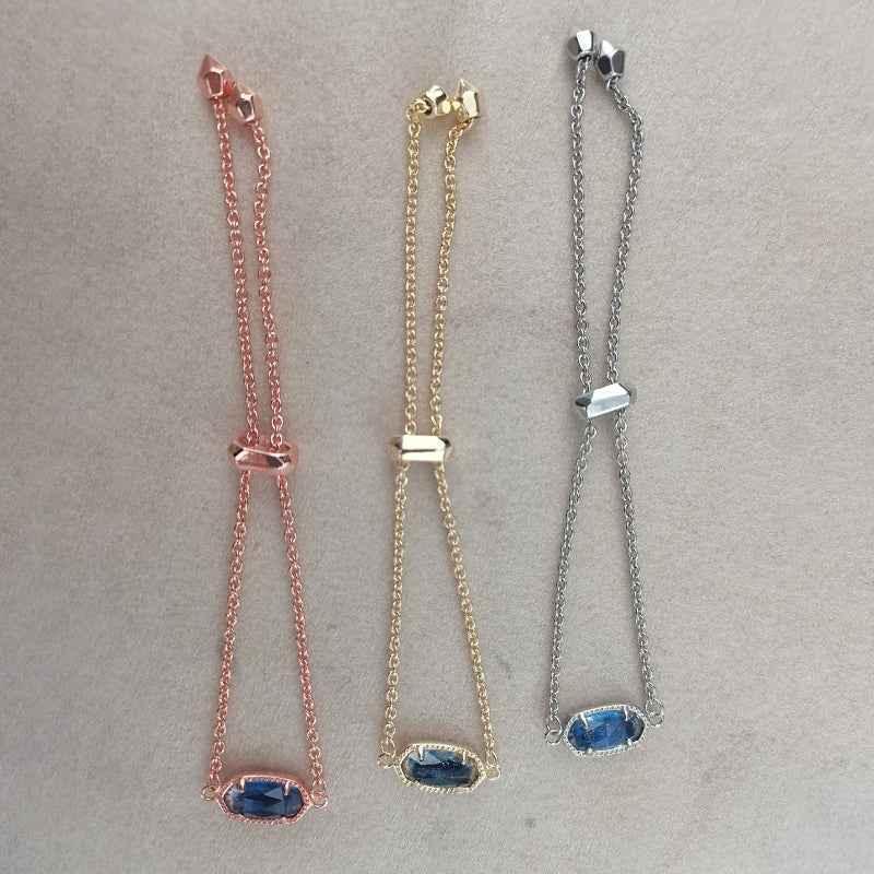 Elisa beaded chain bracelet with oval dark blue stones; rose gold, gold, and silver chains