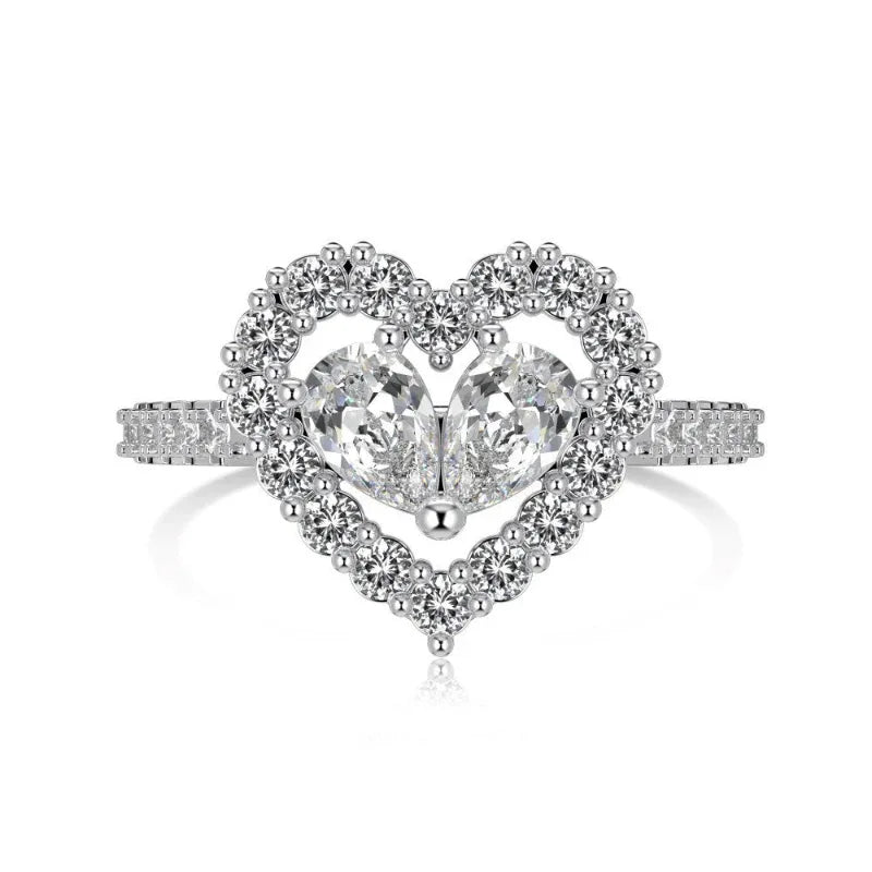 Heart CZ ring in silver with two clear pear-shaped stones and pavé border