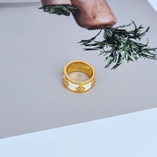 Gold-tone wide enamel band ring with white enamel inset and logo detail