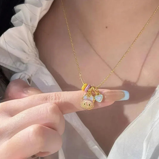 Gold-tone necklace with Labubu face charm, heart pendant, and purple bead accent