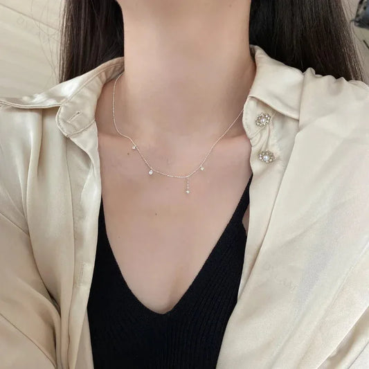 Dainty infinity necklace with small cubic zirconia stones on a white gold tone chain