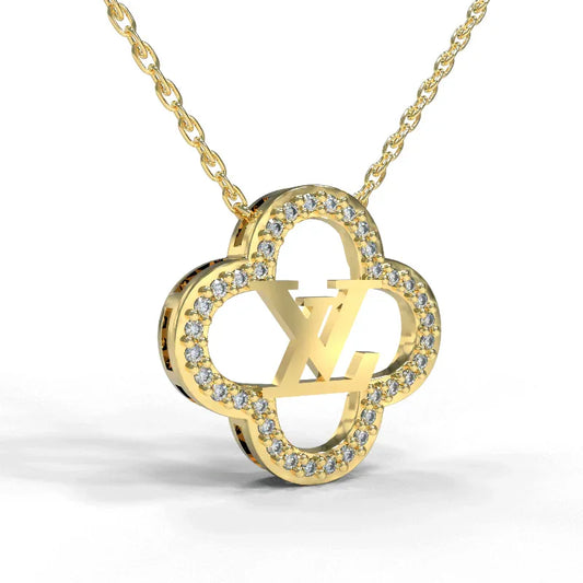 Gold four-leaf clover pendant necklace with pavé-style stones and linked chain
