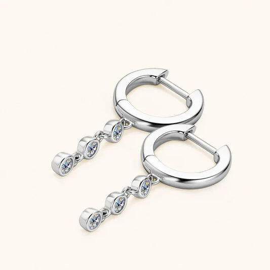 Silver moissanite dangle hoop earrings with three round blue-shimmer stones