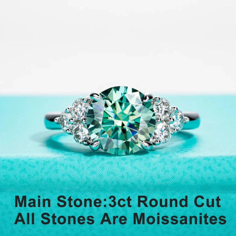 White gold moissanite engagement ring with oval green center stone and round side stones