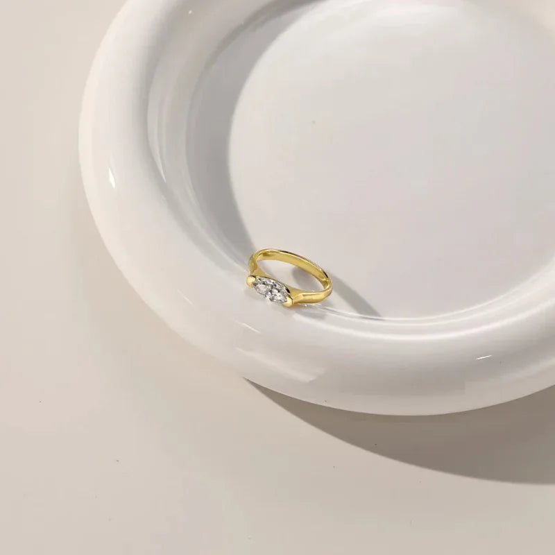 Gold tone oval marquise CZ solitaire ring with open, slim band