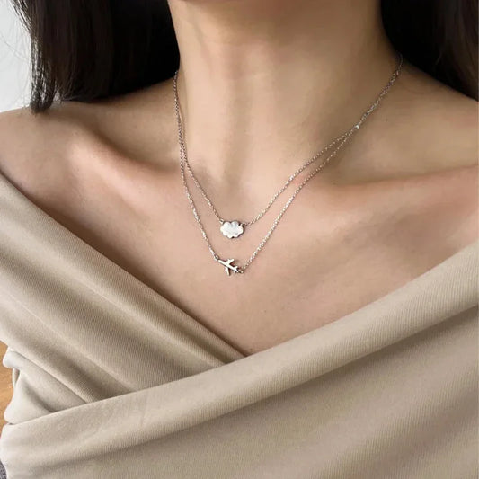 Silver double-layer pendant necklace with a cloud charm and an airplane charm