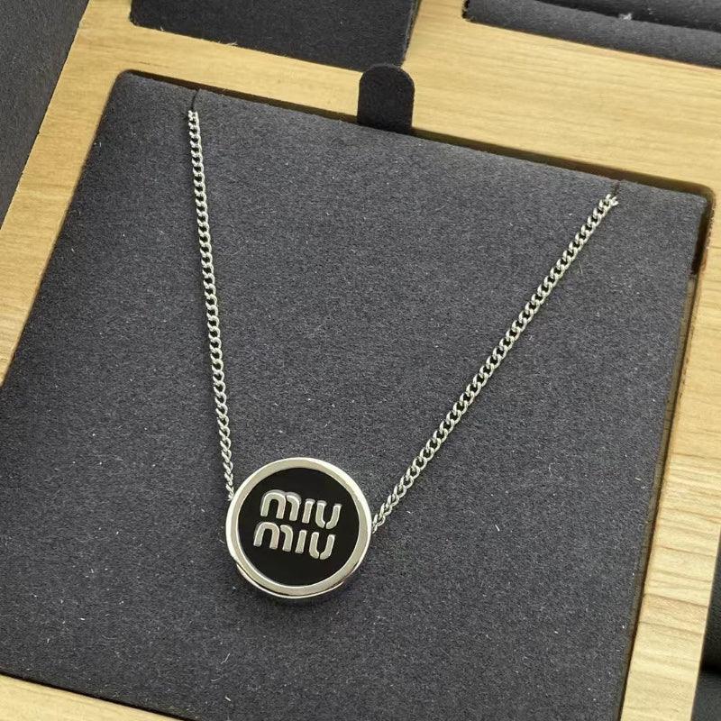 Round black enamel necklace pendant with silver-tone Miu Miu logo and chain