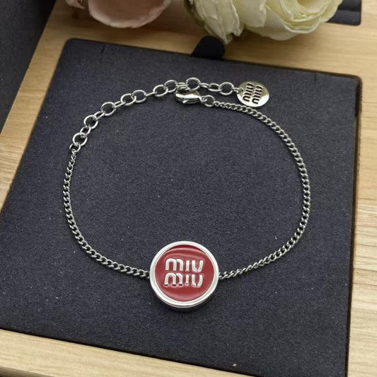 Miu Miu charm bracelet with red enamel round medallion centerpiece and chain links