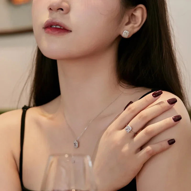Silver necklace with CZ pendant, square CZ ring, and CZ stud earrings