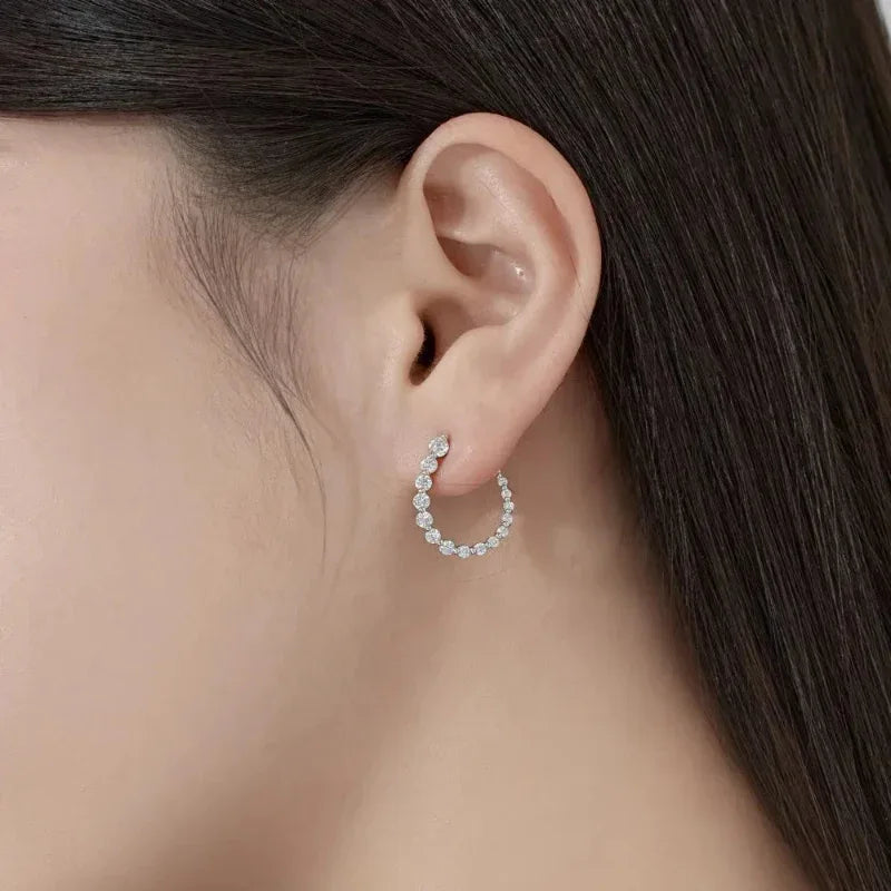 U-shaped hoop earrings with clear CZ stones in a silver-tone setting