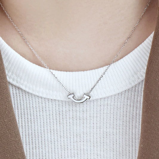 Silver smile shell pendant necklace with U-shaped charm on a fine chain