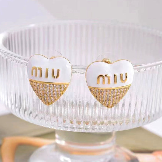 Heart stud earrings with white enamel top and gold-tone pavé bottom