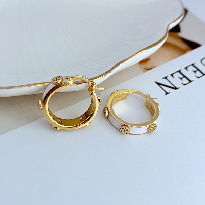 Gold-tone enamel logo hoop earrings with white enamel and gold logo studs