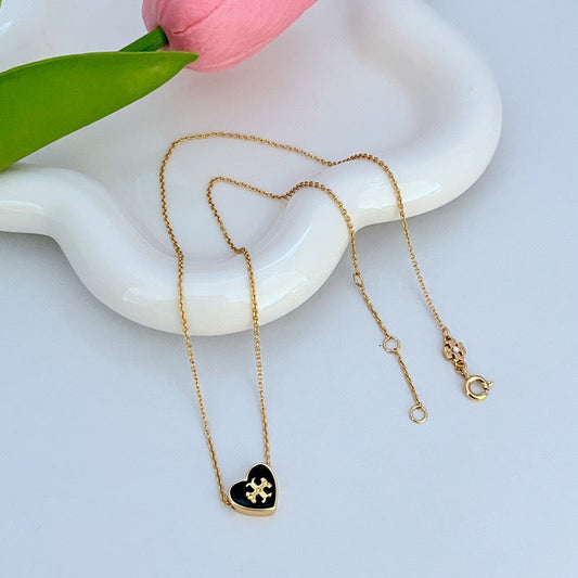 Heart pendant necklace with gold-tone chain and black enamel heart pendant