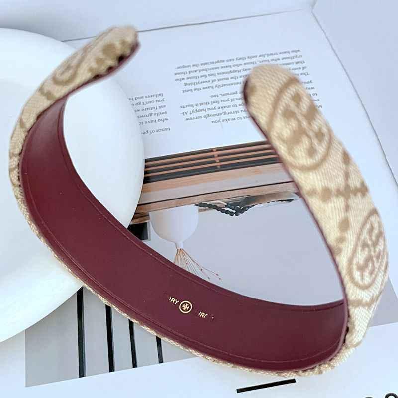Apricot/beige logo-pattern fabric headband with burgundy inner lining