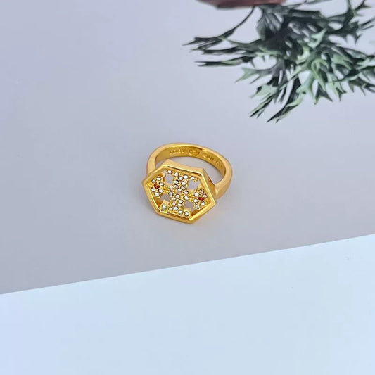 Gold hexagonal diamond ring showing top cluster of clear stones on a wide band