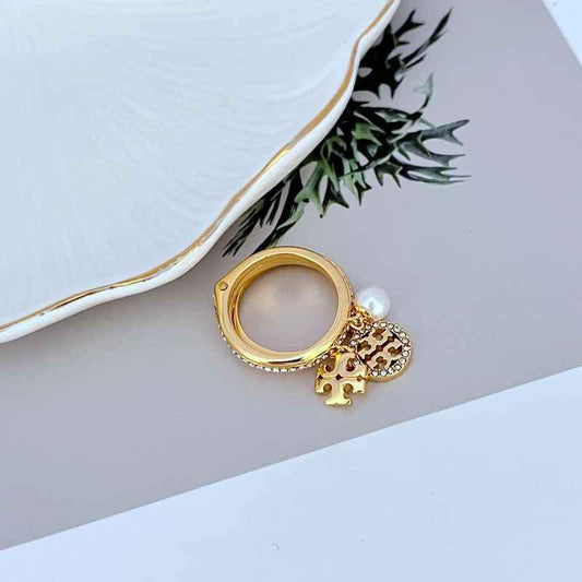 Gold-tone ring set with pearl accent and rhinestone oval charm