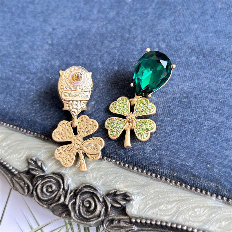 Gold-tone four-leaf clover drop earrings with green faceted teardrop stones and pavé clovers